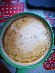 Tasse mit Milchkaffee und leckerem Milchschaum